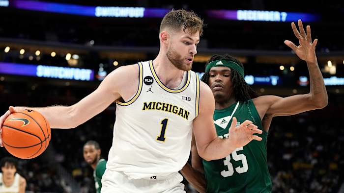 Michigan center Hunter Dickinson dribbles